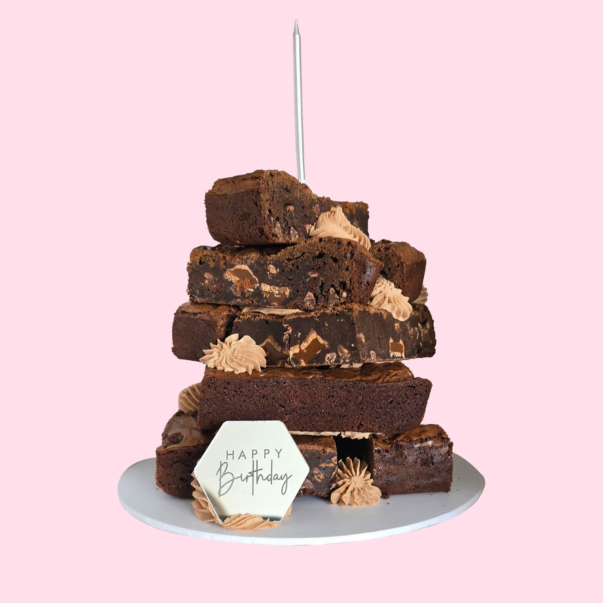 Layered chocolate brownie stack with Happy Birthday plaque and buttercream swirls, featuring assorted flavours