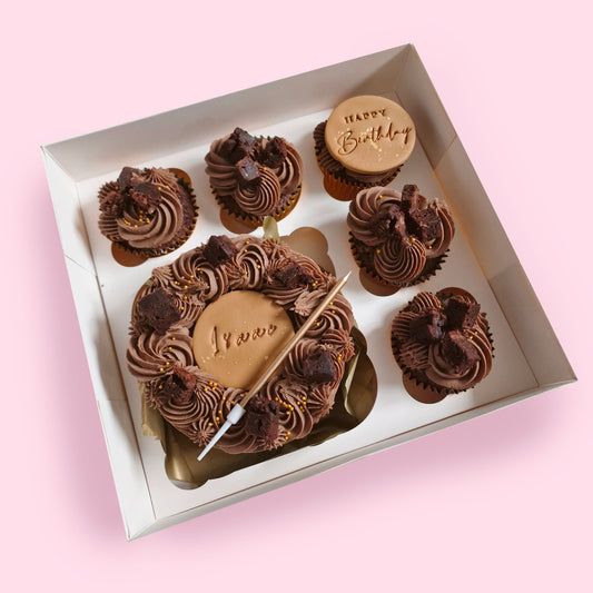 Mini chocolate bento cake with five matching cupcakes, personalised with name “Isaac” and Happy Birthday disc, boxed for gifting